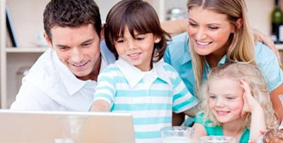 Family seated at laptop booking an appointment online with a doctor